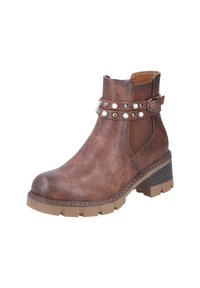 Bottine marron avec un cuir texturé, dotée d'une sangle à boucle et de rivets ronds. La semelle en caoutchouc épaisse offre stabilité et adhérence.