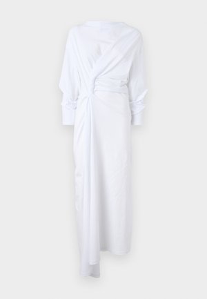 White long-sleeve dress, featuring a twisted detail at the waist, soft fabric, relaxed fit, and a flowing design down to the ankles.