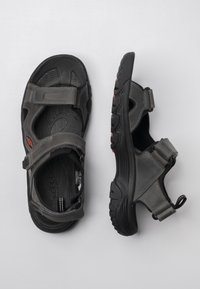 Gray sandals with adjustable Velcro straps, featuring a textured upper and a durable black rubber sole with a tread pattern.