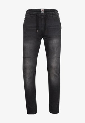 Pantalons jogger en denim noir avec taille à cordon, coupe fuselée, décoloration subtile, détails de couture et poches avant.