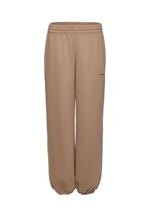 Beige színű, laza szabású melegítőnadrág gumis derékpánttal és szegélyekkel, finom kis logós felirattal a felső combnál.