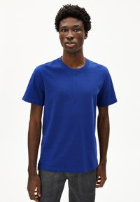 Königsblaue kurzärmlige T-Shirt mit Rundhalsauschnitt, aus glattem Baumwollstoff gefertigt, mit lockerem Schnitt und nahtlosen Schultern.