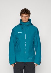 Teal waterproof jacket with a hood, featuring a front zipper, side pockets, and GORE-TEX label. Smooth texture and adjustable cuffs.