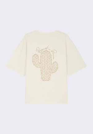 Camiseta de algodón crema de manga corta con un gráfico de cactus dorado con un patrón geométrico y el texto "Project Paris" arriba.