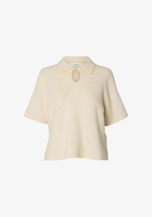 Bež bežična polo majica s kratkim rukavima i polo ovratnikom, s detaljem proreza na vratu. Mekana tekstura i opušteni kroj.