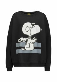 Sweat-shirt noir arborant un graphique de Snoopy en blanc avec des lunettes de soleil. Comprend des rayures grises horizontales en bas. Matériau doux, coupe décontractée.