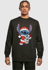 Felpa nera in cotone con un personaggio dei cartoni animati in abbigliamento natalizio che tiene in braccio una bambola più piccola, con dettagli blu e colori vivaci.