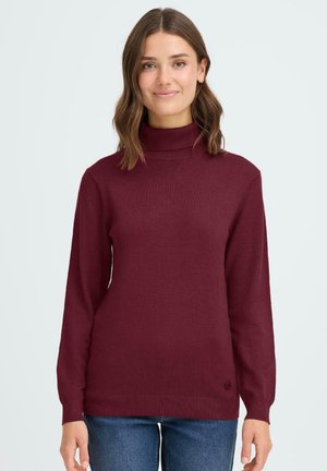 Burgundy polotröja i ribbad tyg, med långa ärmar och en smal passform, med en rund logodetalj nära nederkanten.