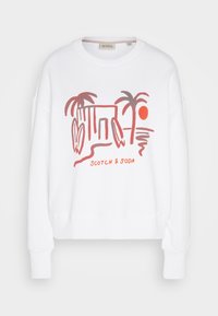 White sweatshirt with long sleeves, featuring a colorful graphic design of palm trees, a sun, and a structure, branded with "SCOTCH & SODA."