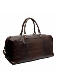 Sac de voyage en cuir marron avec une texture lisse, deux poignées supérieures et une poche zippée sur un côté. Présente des coins et des coutures renforcés.