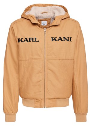 Tan hooded jacket with black embroidered "KARL KANI" text. Features a zip closure and soft, beige fur lining for added warmth.