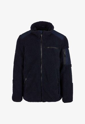 Fleecejakke i mørk marineblå, med høy krage, glidelås foran, to glidelåslommer på sidene, og akksentpaneler på skuldrene. Teksturen er myk og luftig.