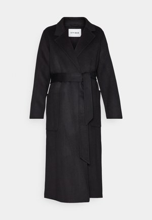 Long black wool coat with lapel collar, long sleeves, two front pockets, and a waist tie belt, labeled IVY OAK.