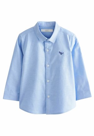Chemise à manches longues bleu clair pour tout-petit, avec col, patte de boutonnage à l'avant, et petit dinosaure bleu foncé brodé sur la poitrine gauche.