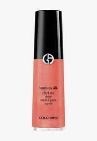 Teinte de joues corail rose dans un contenant cylindrique au fini mat. Présente un capuchon noir brillant et un accent de logo argenté. Le texte est imprimé sur le corps.