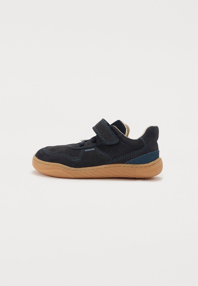 Dark blue suede sneaker with a light brown rubber sole, featuring a hook-and-loop strap and blue accents on the side.