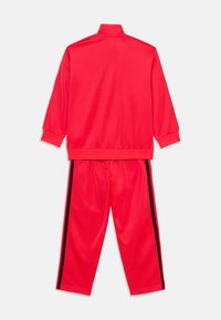 adidas Originals FIREBIRD UNISEX  - Tepláky - lucid red