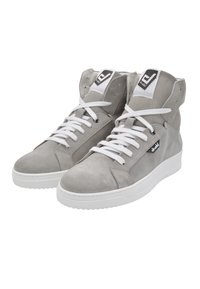 High-top sneakers in light gray suede with white laces and sole. Features a black logo patch on the outer side. Smooth texture, rounded toe.