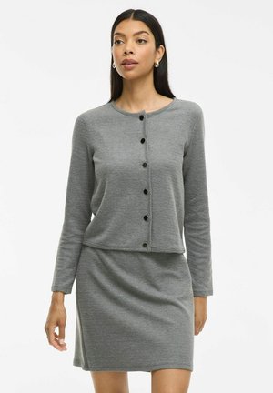 Cardigan en tricot côtelé gris avec des manches longues, un col rond et des boutons noirs, associé à une robe ajustée assortie. Texture et design simples.