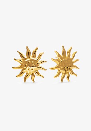 Pendientes de botón dorados con forma de sol y rayos irregulares y texturizados sobre fondo blanco.
