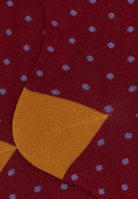 Maroon socks with small light blue polka dots and contrasting mustard yellow heel and toe sections.