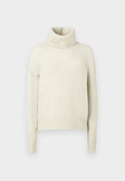 Φωτεινό μπεζ ζιβάγκο πουλόβερ φτιαγμένο από μαλακό, φουντωτό ύφασμα. Διαθέτει ριχτό λαιμό και μανσέτες. Κουτί σχήμα με χαμηλωμένους ώμους.