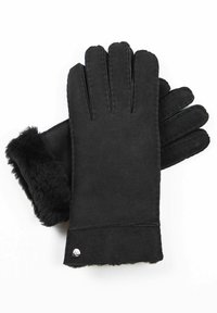 Schwarze Handschuhe aus weichem Material mit einem Fellbund, mit fünf Fingern, genähten Details und einem kleinen metallischen Akzent nahe dem Handgelenk.