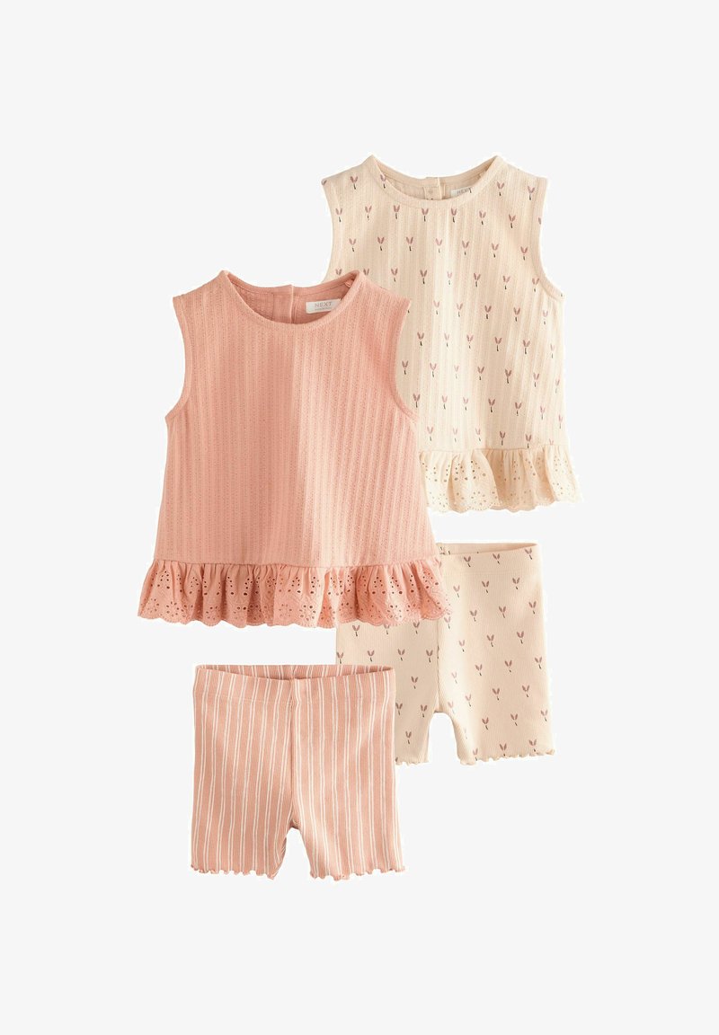 Two children's outfits: peach ribbed top with ruffled eyelet hem, cream top with pink bunny pattern; striped peach shorts and patterned shorts.