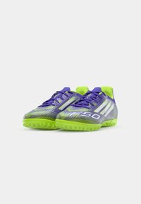 Purple and green athletic shoes with textured surface, lace-up closure, and patterned accents. Features a prominent "F50" logo on the side.