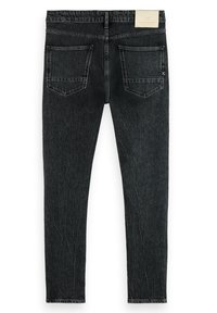 Jeans de denim negros ajustados con un acabado desgastado, cinco bolsillos y una etiqueta en la cinturilla. Presentan costuras decorativas y un tejido texturizado.