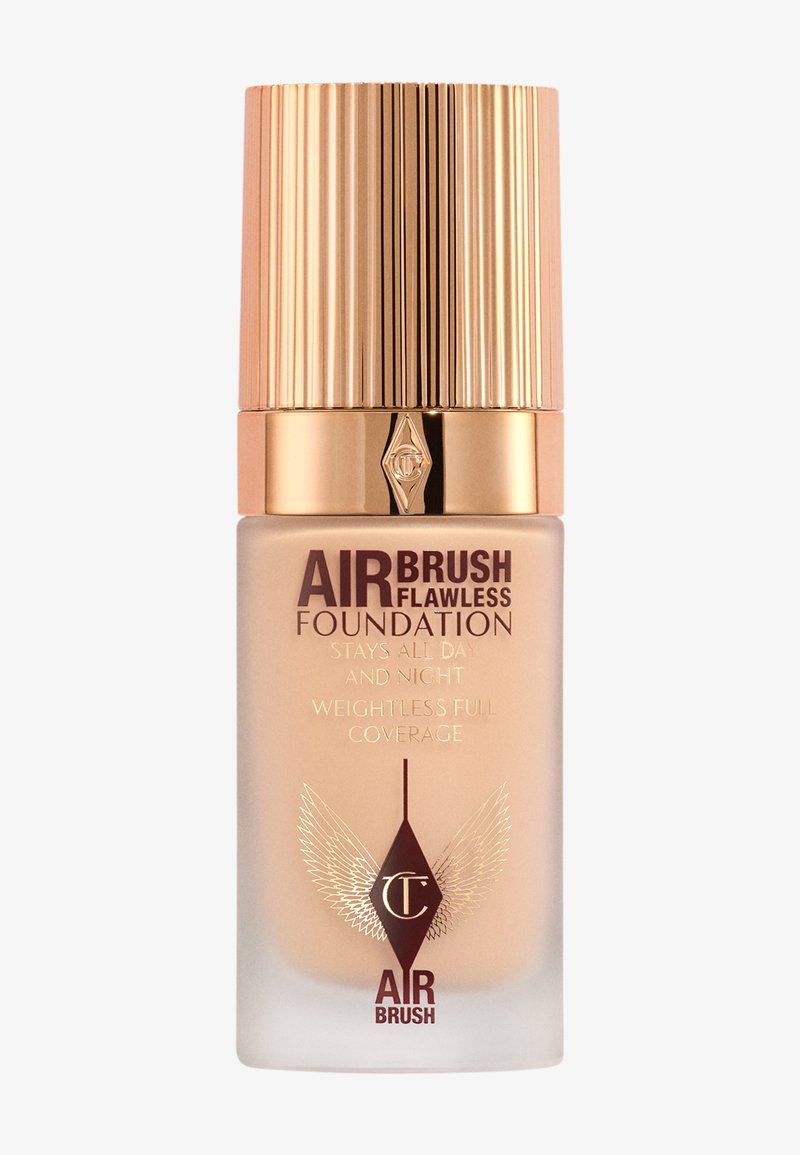 Air Brush Flawless Foundation in a frosted glass bottle with a gold ribbed cap. Features embossed logo and text in dark shades.
