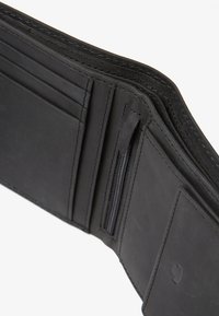 Black leather wallet featuring multiple card slots, a zippered pocket, and smooth texture with neat stitching. Measures approximately four inches wide.