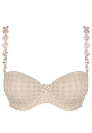 Beige pehmeä rintaliivi ruudullisella kuviolla, pitsinauhat ja kukka-akseli keskellä. Pehmeä rakenne ja kontrastivärit yksityiskohdat.