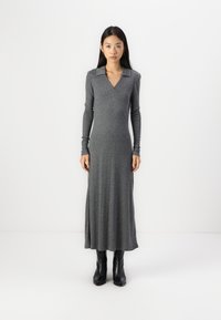 Long gray dress with a V-neck and collar, made from a soft, stretchy fabric. Features long sleeves and a fitted silhouette, reaching mid-calf.