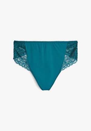 Turkio audinio trumpikių kelnaitės su sudėtingomis nėrinių šoninėmis detalėmis. Lygus paviršius, vidutinio aukščio dizainas ir banginės nėrinių krašteliai prideda detalizacijos.