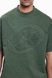 Green cotton T-shirt featuring a textured, embroidered circular logo design on the front, with a crew neckline and short sleeves.
