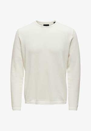 Kremowa bluza z długim rękawem o fakturze wafelka, z prążkowanymi mankietami i okrągłym dekoltem. Prosta i uniwersalna.