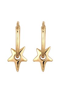 Boucles d'oreilles en forme de créoles de couleur dorée, présentant une étoile avec un trou circulaire au centre. La texture lisse et la finition brillante mettent en valeur le design.