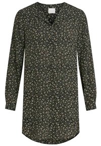 Svart tunika med V-ringning, långa ärmar och en lös passform. Den har ett prickigt mönster i kräm och guld, med rundad fåll och mjukt tyg.