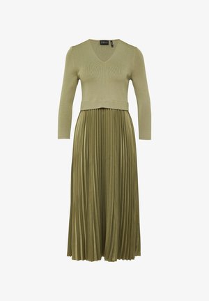 Olivengrünes Kleid mit einem gerippten Strick-Oberteil und einem gefalteten, fließenden Rock. Mit V-Ausschnitt und drei Viertel langen Ärmeln. Weicher Stoff.