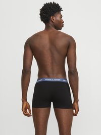 Boxer neri con un elastico azzurro chiaro riportante ripetutamente il nome del marchio "JACK & JONES". Tessuto morbido, design attillato.