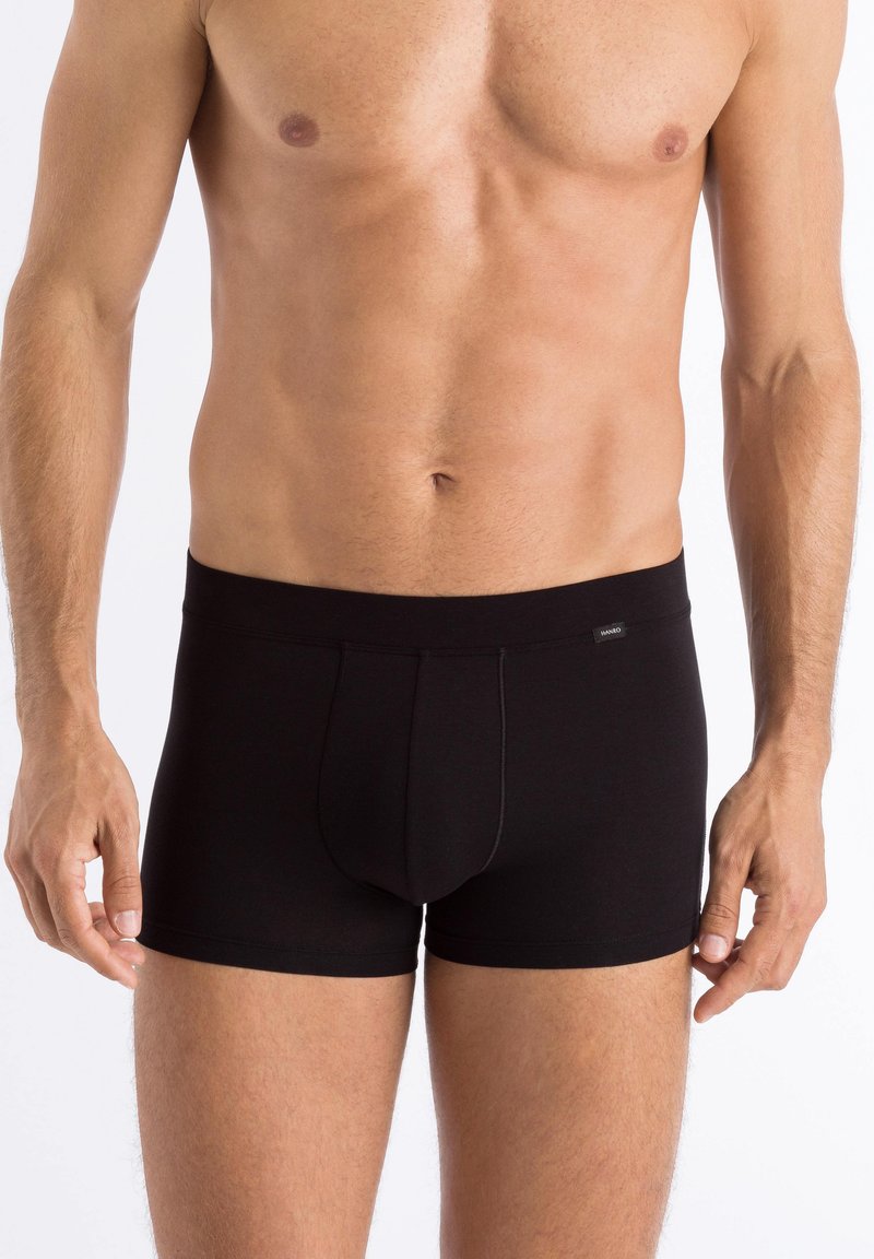 Black cotton boxer shorts with a fitted design, elastic waistband, and a contrast stitching detail. Material appears smooth and stretchy.