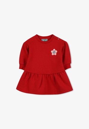 Czerwona bawełniana sukienka z okrągłym dekoltem, krótkimi bufkami i rozkloszowanym dołem. Posiada kwiatowy emblemat na piersi oraz guziki na ramieniu.