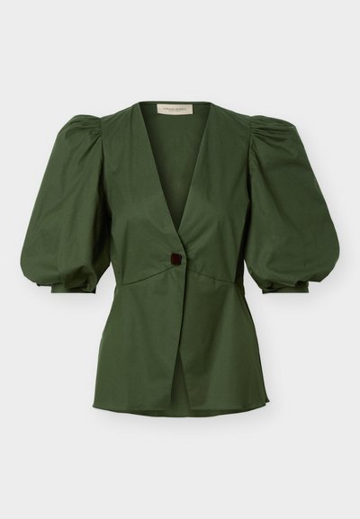 Πράσινη μπλούζα με βαθύ V-λαιμόκοψη, ένα μόνο κουμπί στο μπροστινό μέρος και μεγάλα φουσκωτά μανίκια τριών τετάρτων, παρουσιάζεται σε απλό λευκό φόντο.