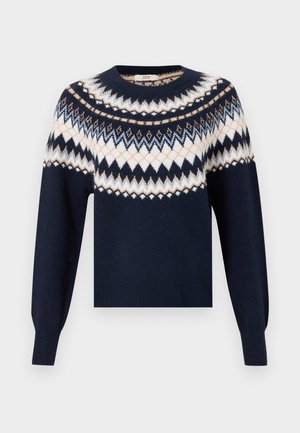 Pull bleu marine à manches longues avec des motifs en zigzag et en losange blancs, beige et bleu clair sur la poitrine et les épaules.