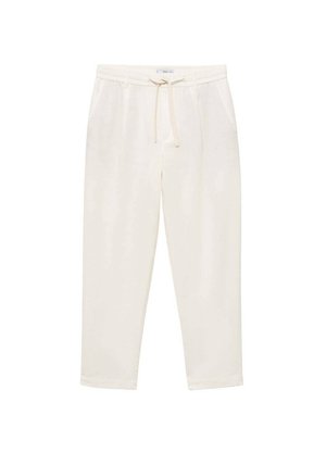 Light cream jogger pants made of soft fabric, featuring an elastic waistband with drawstring, side pockets, and tapered legs.