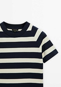 Navy and cream striped short-sleeve knit top with a ribbed crew neckline and smooth texture. Features alternating wide and narrow stripes.