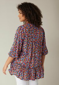 Bloemenprintblouse in meerdere kleuren met korte pofmouwen, gerimpelde zoom en een losse fit, gemaakt van lichtgewicht stof.