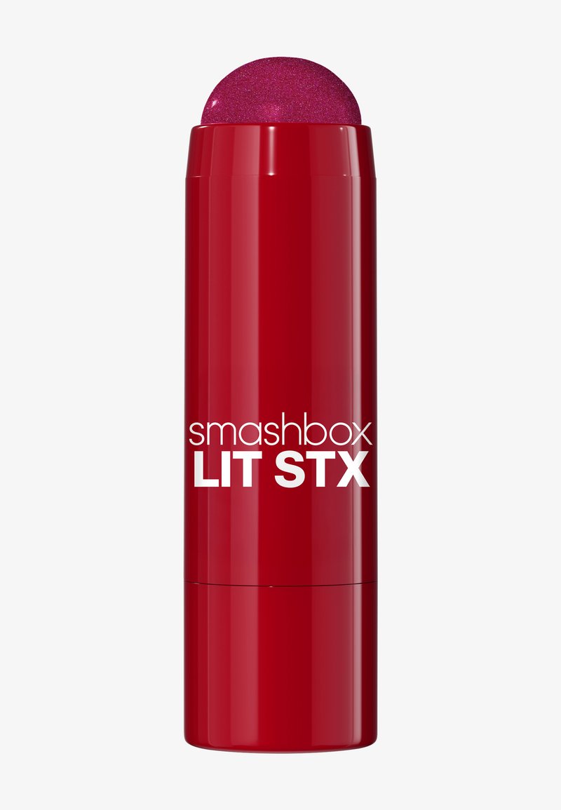 Tube rouge de rouge à lèvres Smashbox Lit Stx avec un dessus rond pailleté rose. Étiquette à l'avant en texte blanc. Fini lisse et brillant.