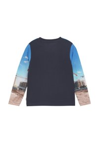 Mörkblå långärmad T-shirt med ljusblå ärmar; har ett tryck av en byggarbetsplats på ärmarna. Tillverkad av mjukt tyg, med rund halsringning.